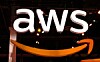 Large illuminated AWS logo with the orange smile arrow on a dark stage backdrop.