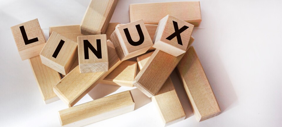 Wooden blocks with the letters L, I, N, U and X on a white background.